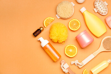 Shower gels with bath supplies on color background