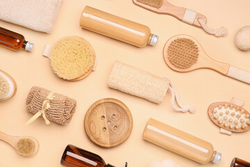 Shower gels with bath supplies on color background