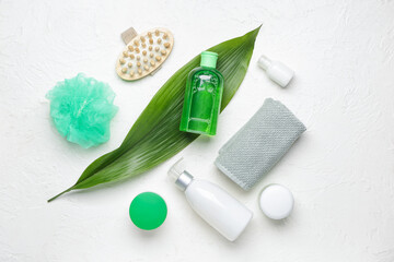 Shower gels with bath supplies on white background