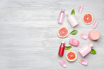 Shower gels with bath cosmetics on wooden background