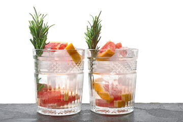 Glasses of healthy cocktail on table against white background