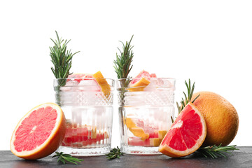 Glasses of healthy cocktail on table against white background