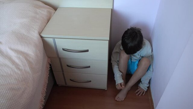 4K Punished boy sitting in the corner
