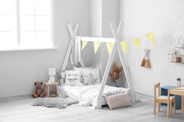 Stylish interior of children's room with bed