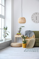 Interior of modern room with sofa and houseplants