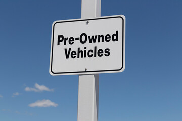 Pre Owned Vehicles sign at a Used Car Dealership.