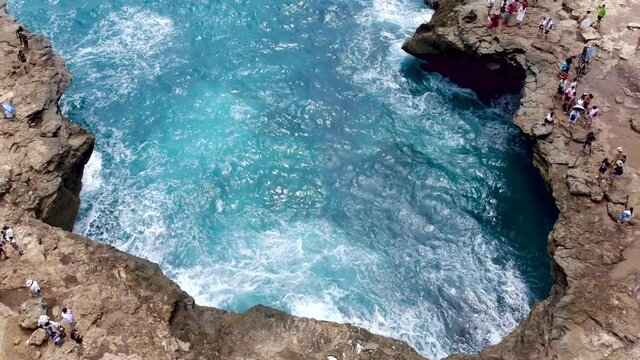 Drone shot of the devil's tear blowhole revealing blue ocean horizon in Bali, Indonesia