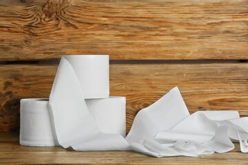 Rolls of toilet paper on wooden background