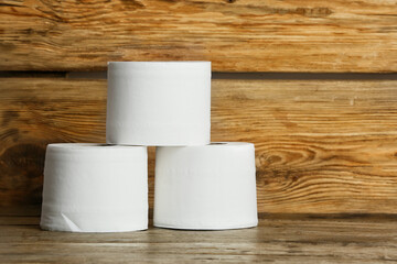 Rolls of toilet paper on wooden background