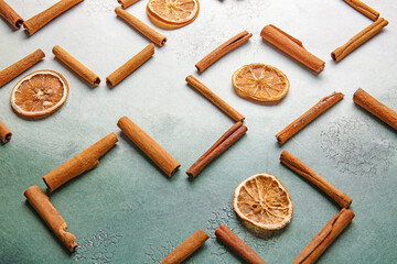 Composition with dry orange slices and cinnamon sticks on color background. Zen concept