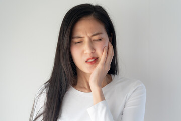 Asian teen touch cheek feel toothache pain Teeth and gum face expression