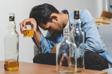 Alcoholism concept. Young man drinking alcohol too much.