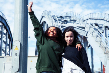 young cute teenage girls together in industrial zone happy smiling having fun, big city lifestyle...