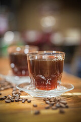 two glass cup of coffee and beans