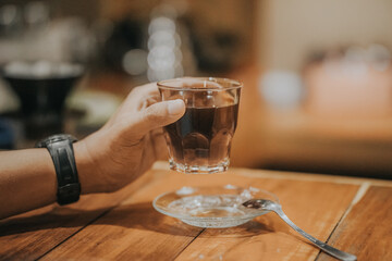 hand holding a cup of espresso coffee