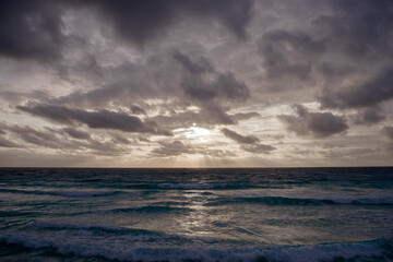 Naklejka na ściany i meble Dawn on the Caribbean Sea. Clear sky with small clouds.