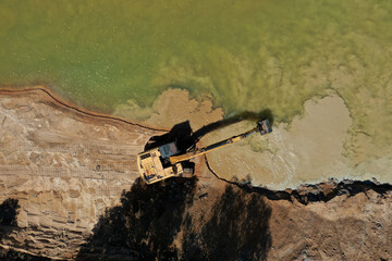 Environmental conservation issue. Machinery mining river, causing siltation and pollution