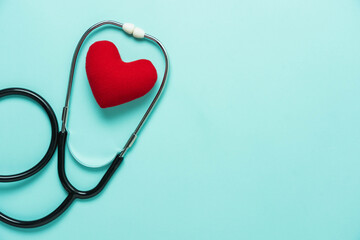 Table top view aerial image of accessories healthcare & medical with Valentines day background concept.Flat lay stethoscope with sign treatment heart shape sick on bule paper.National Organ Donor Day.