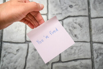 business concept of you're fired from the company in sticky note