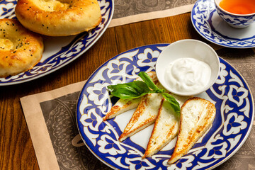 Grilled cheese with white sauce beer appetizer in a plate on the table
