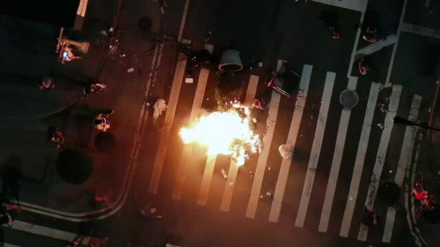 protestors lighting fire in crosswalk intersection after police officers killed , people take to the streets in New York City NYC