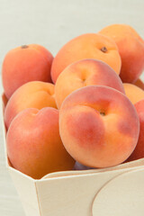Fresh apricot in wooden box as healthy snack or dessert containing vitamins