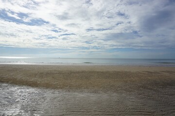 Fototapeta na wymiar Beautiful blue and cloudy sky with the beautiful sand beach in HuaHin Thailand