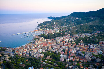 Panoramic view of marina in Santa Margherita Ligure at purple sunset. Italian landscape with colorful traditional houses and Ligurian Sea, near Portofino, Italy.