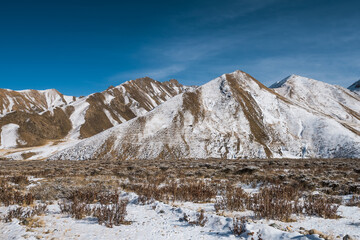 lanscape with barren mountain which is covered with ice