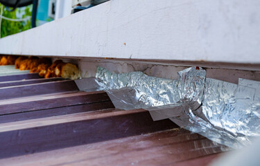 Roof repairing by using aluminum foil tape to prevent water leak before rainy season