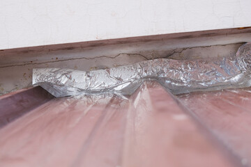 Roof repairing by using aluminum foil tape to prevent water leak before rainy season