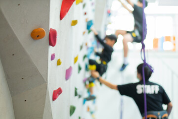 blur kid climbing a wall , children rock climbing
