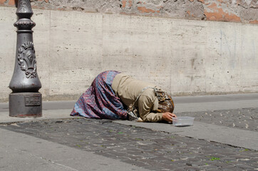 Woman Praying in the street