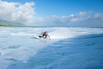 Fototapeta na wymiar Kitesurfer rides on the waves of the Indian Ocean on the island of Mauritius