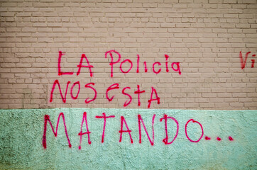 Anonymous Graffiti Written in Bogot&aacute;:  "La Policia nos esta matando" meaning "Police is killing us"