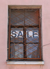 The barred window of the apartment for sale