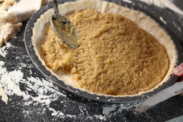 Leveling honey filling with spoon. Making Shoofly Tart Series.