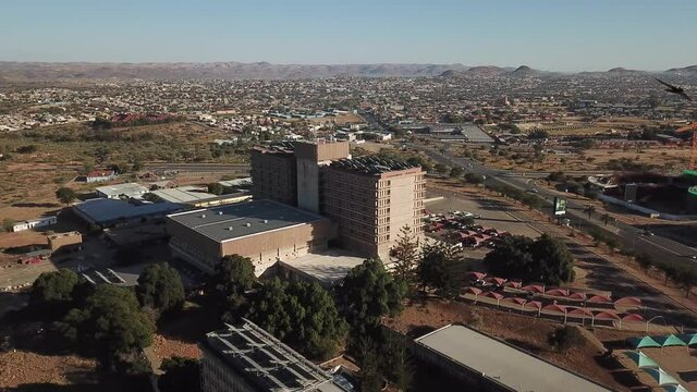 4K aerial drone summer sunny day video of Windhoek Katutura suburb large state hospital near B1 main highway in Namibia's capital in central highland Khomas Hochland of Namibia, southern Africa