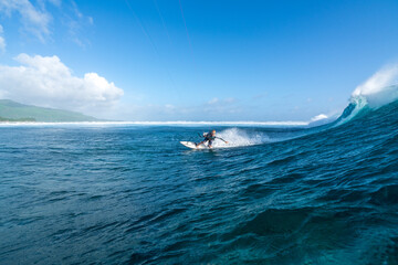 Kitesurfer rides on the waves of the Indian Ocean on the island of Mauritius