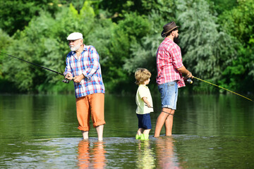 Generations men. Grandfather, father and son are fly fishing on river.
