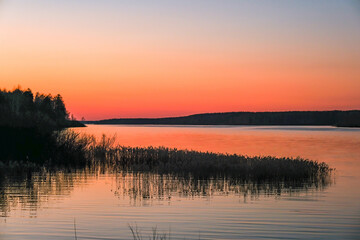Red-orange sunset over the Uvodsky reservoir in a quiet spring evening.
