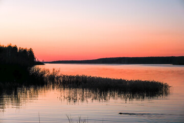 Pink sunset over the Uvodsky reservoir in a quiet spring evening.
