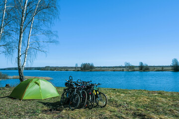 Bicycles and a light green tent on the shore of the Uvodsky reservoir.
