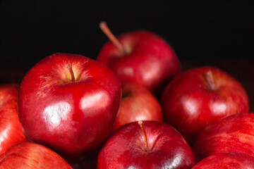 Many organic red apples with black background