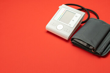 Blood pressure concept. Medical test health hypertension for doctor and patient. Monitor sphygmomanometer for check blood pressure isolated on red background. Hospital diagnostic technology.