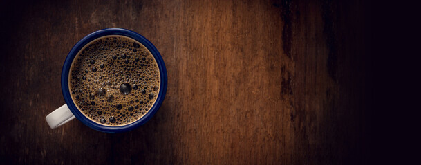 Cup of coffee on wooden background. Copy space. Top view. Flat lay. Panorama