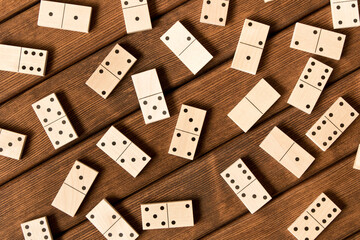 Domino. A game of dominoes on a wooden table.