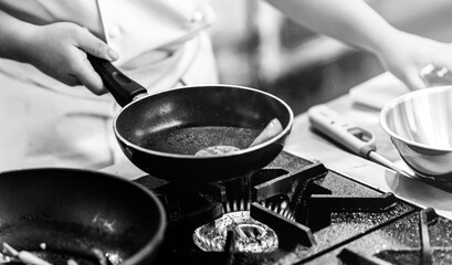 Chef cooking in a kitchen, chef at work, Black & White.