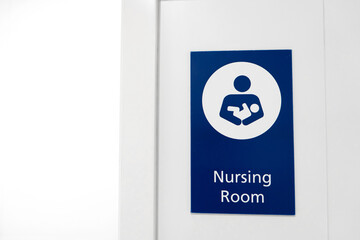 A sign at the entrance to the baby nursing room. Feeding and swaddling children in a public place.