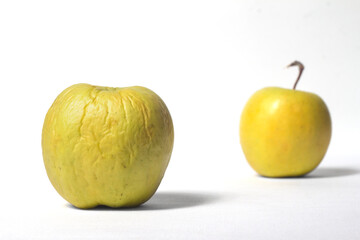 old and fresh apple in perspective